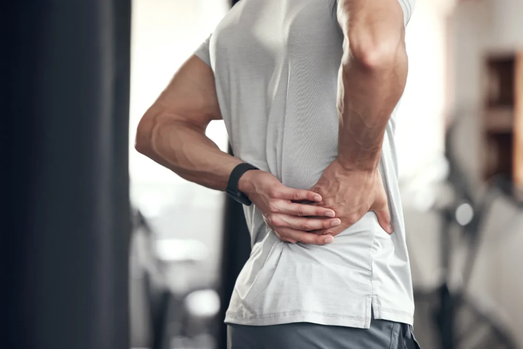 adult man with back pain at the gym 2026 09 24 15 19 16 utc