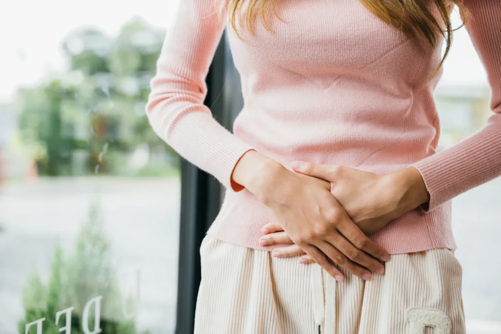 woman with abdominal pain indoor 2026 09 23 19 40 21 utc